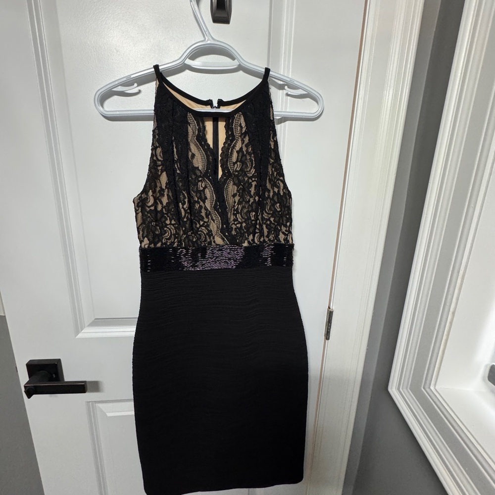 Brian Bailey Chic Black dress with lace, sequin & rouching details.